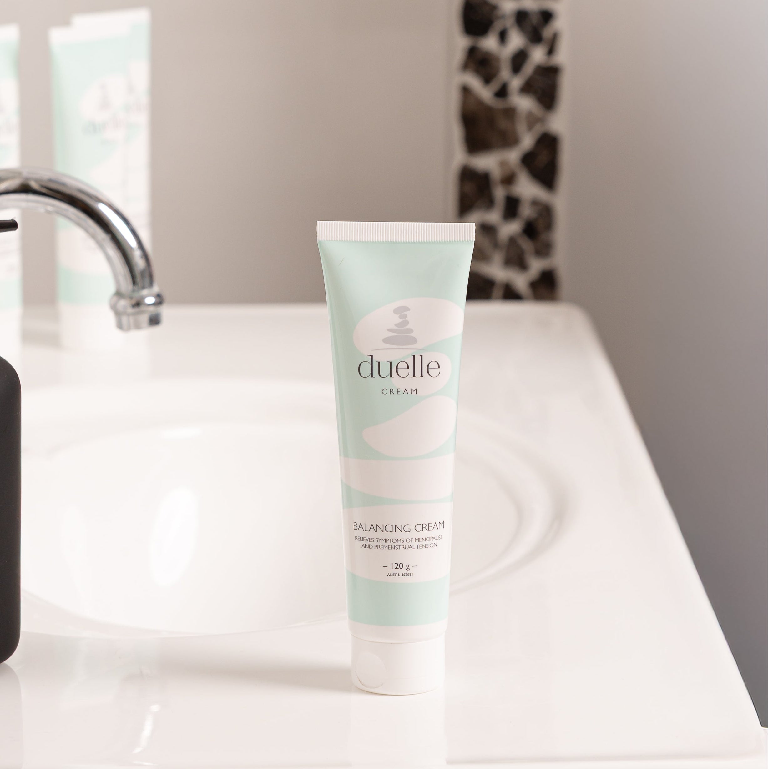 Tube of Cluelle product on a bathroom counter with a blurred background